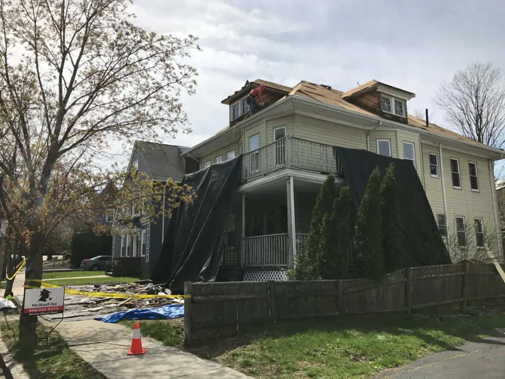 Roofers installing weather-resistant shingles on a residential property