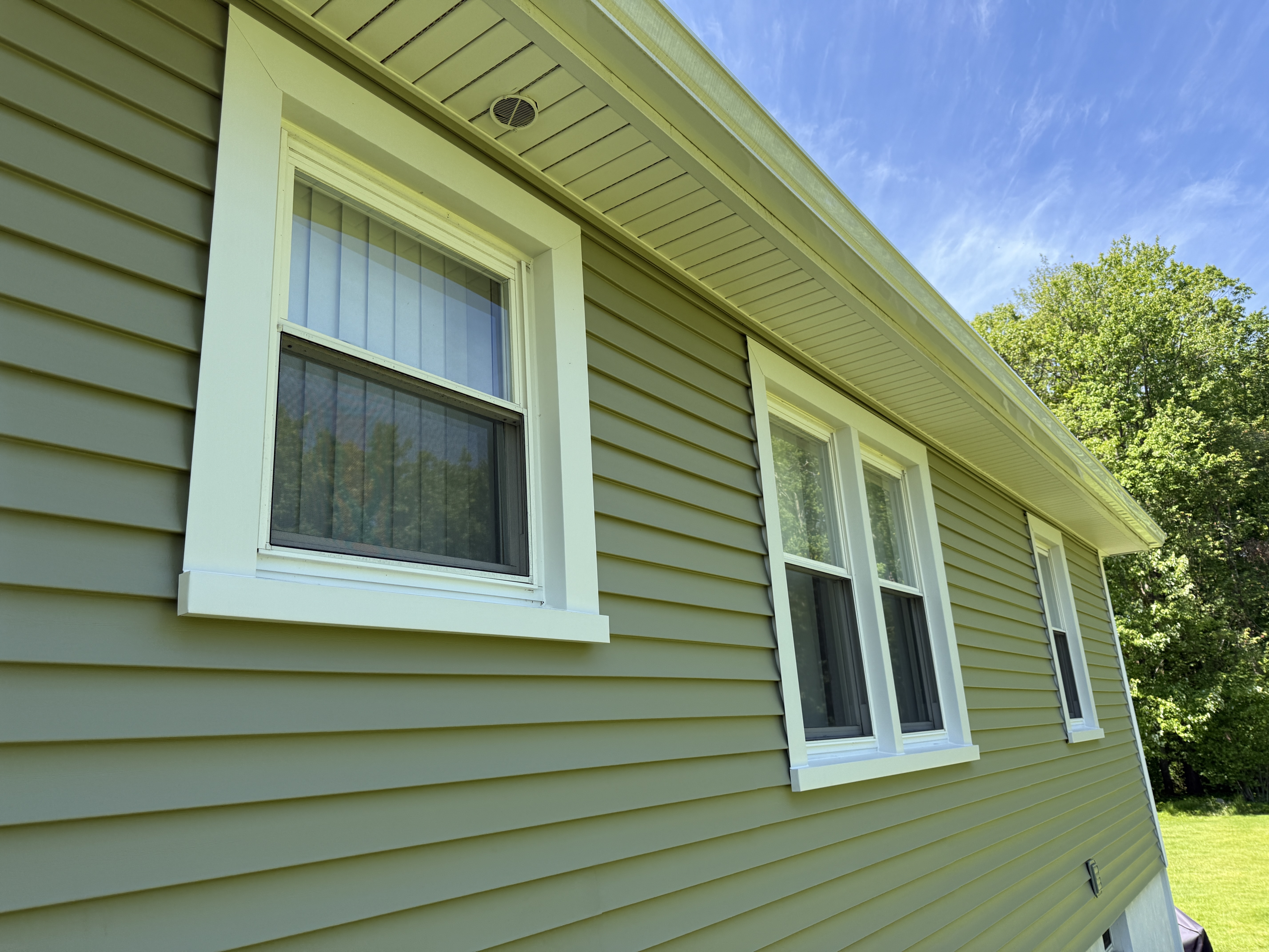 Home with new vinyl siding installed by MR. ROOF. INC