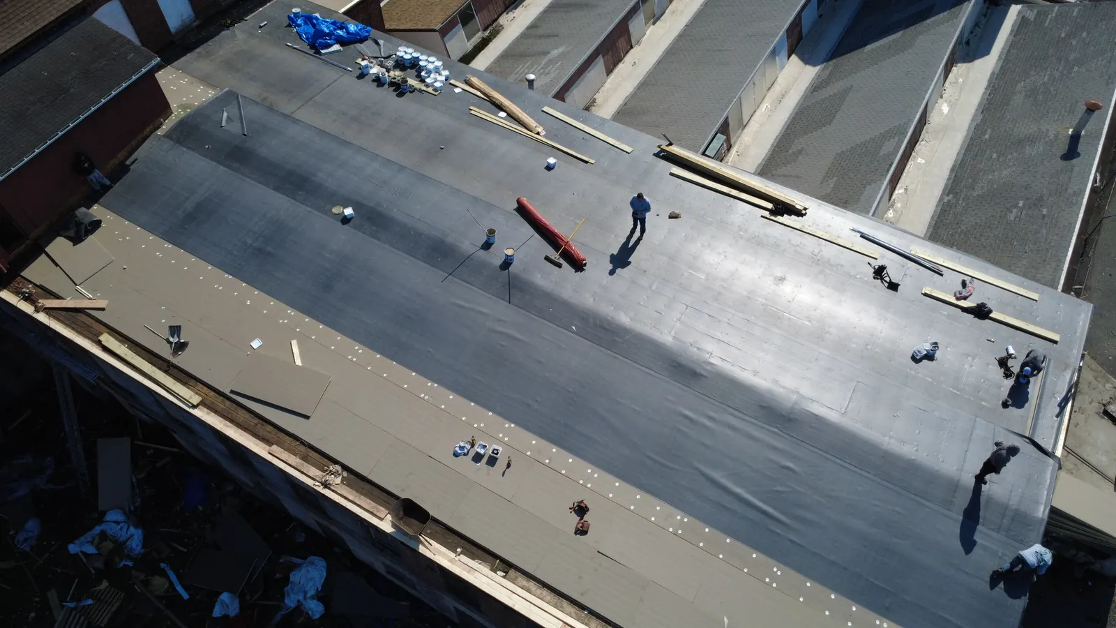 Aerial view of EPDM membrane installation on a Central Falls commercial roof