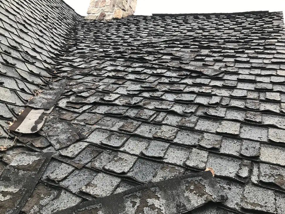 Severely deteriorated roof shingles identified during an inspection