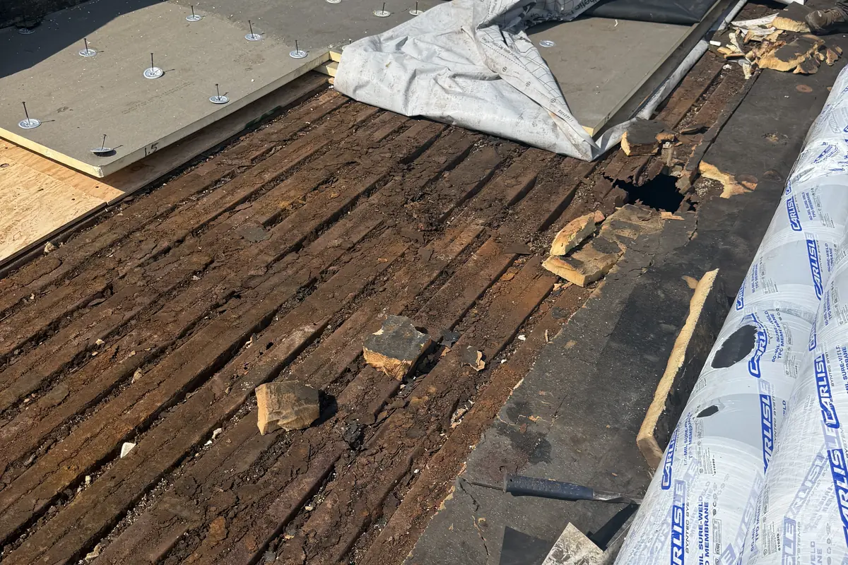 Damaged commercial flat roof decking exposed during repair in Pawtucket