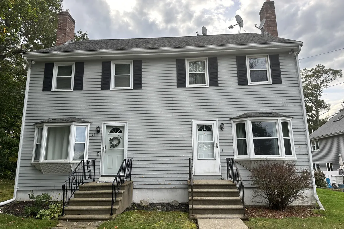 Home exterior before siding and roof replacement